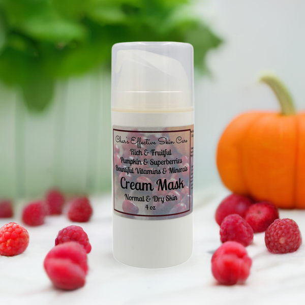 Rich and Fruitful Pumpkin Enzyme and Superberries Cream Mask/4 oz White Airless Treatment Bottle artistically surrounded by berries and pumpkin/Mostly Natural/for Normal and Dry Skin
