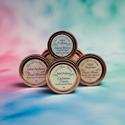 Collection of solid perfume tins with labels on a colorful watercolor background