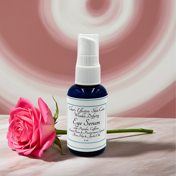 Eye serum bottle with a pink rose on a wooden surface