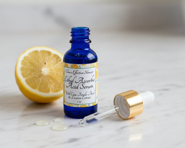 Ethyl Ascorbic Acid Serum with angled dropper top on vanity with drops of the serum.