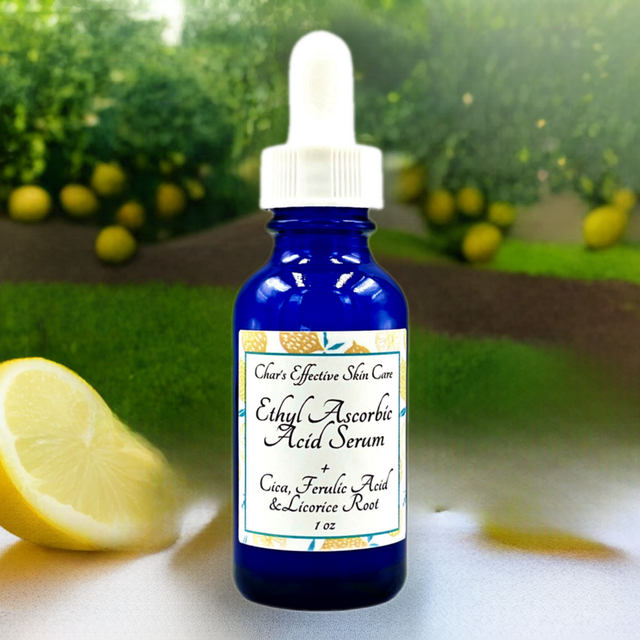 Ethyl Ascorbic Acid Serum with Cica, Ferulic Acid, and Licorice Root/ A Vitamin C Serum for ALL Skin types including Sensitive Skin/ Dark Blue 1 ounce Glass Bottle with White Dropper with citrus and natural lemon orchard background/ Char's Effectives Skin Care